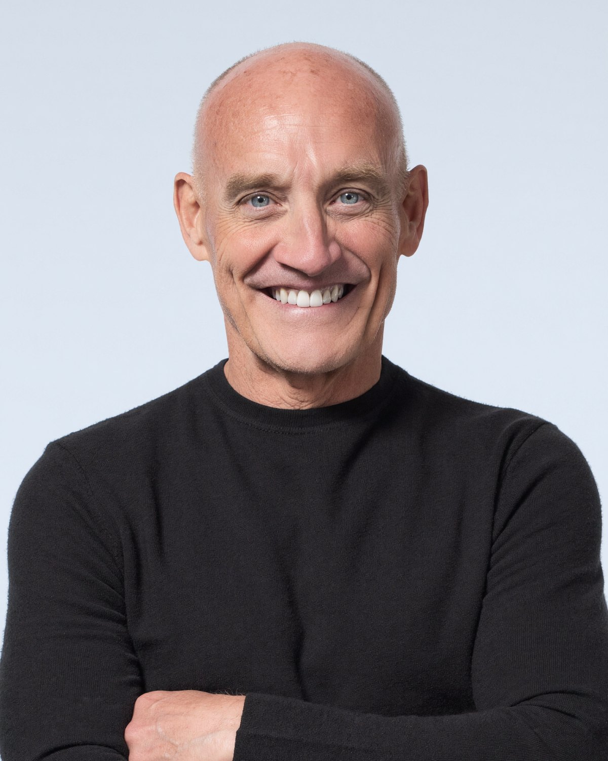 Dr. Adams, arms crossed, smiling