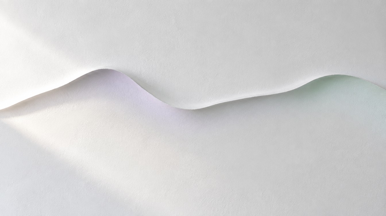 A soft ridge carved across a white plaster wall